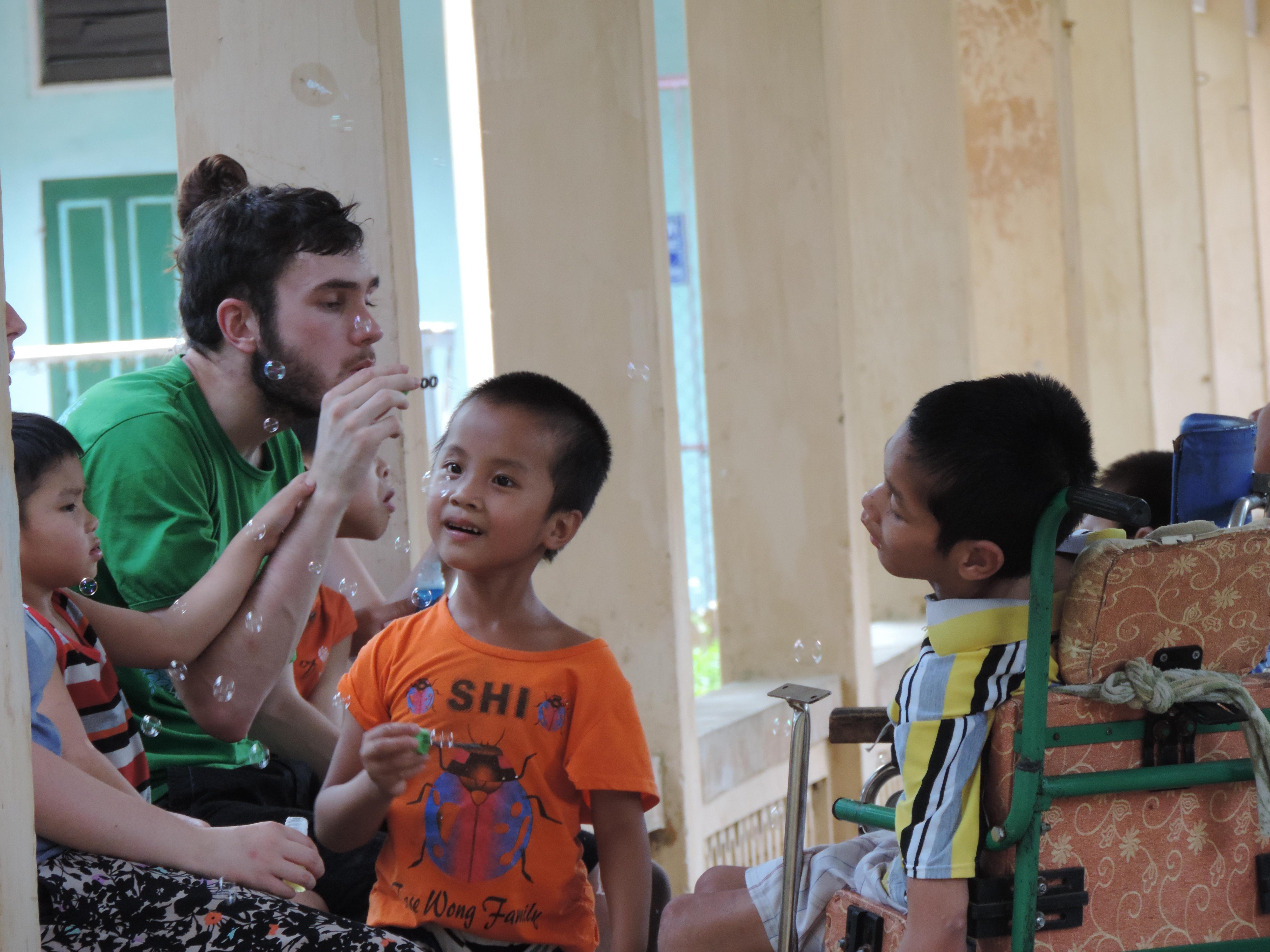 A male intern hard at work and engaging with a group of children during his speech therapy internship in Vietnam, Asia with Projects Abroad. A male intern is pictured hard at work during his speech therapy internship in Vietnam, Asia with Projects Abroad.
